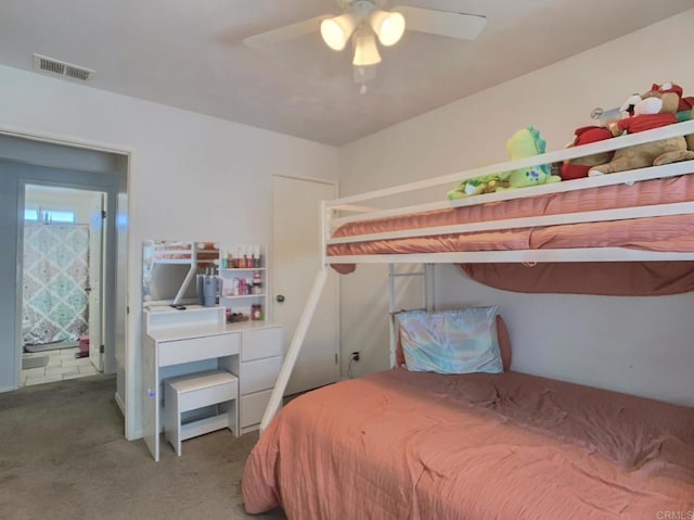 carpeted bedroom with visible vents and a ceiling fan