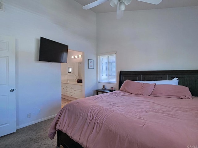 carpeted bedroom featuring ensuite bathroom, ceiling fan, visible vents, and baseboards