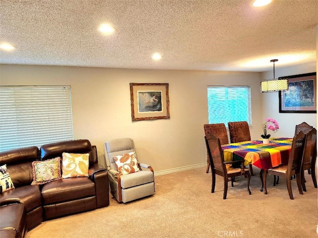 dining space with recessed lighting, light colored carpet, a textured ceiling, and baseboards