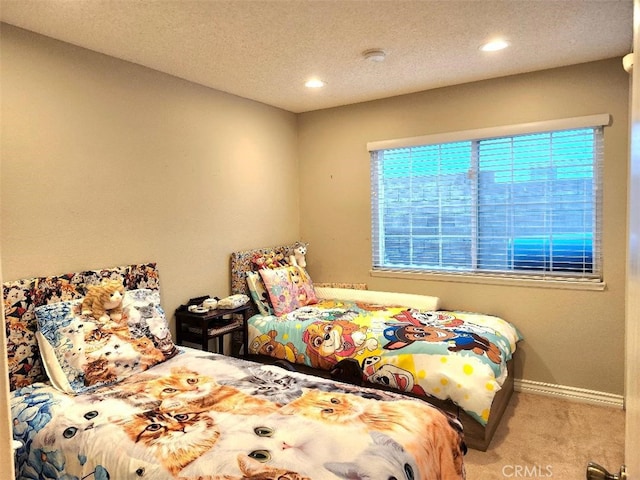 bedroom with light carpet, a textured ceiling, recessed lighting, and baseboards