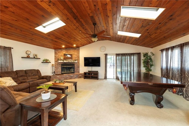 rec room featuring carpet floors, lofted ceiling with skylight, a fireplace, and wood ceiling