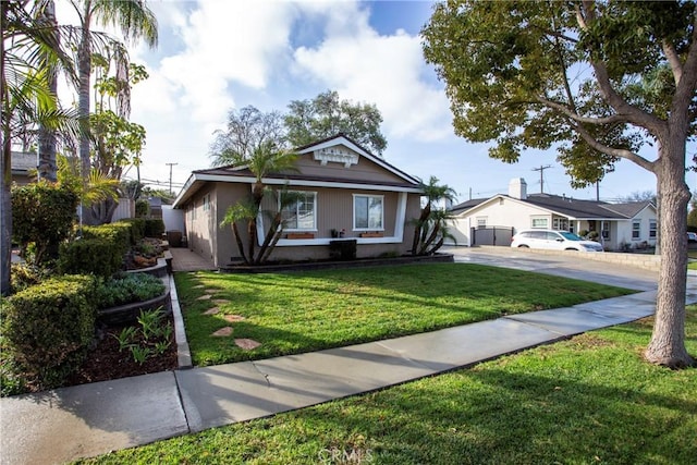 bungalow featuring a front yard and driveway