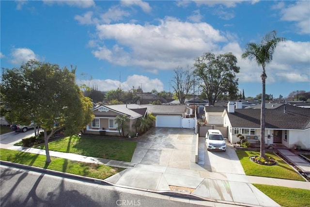 single story home with a residential view, driveway, an attached garage, and a front yard