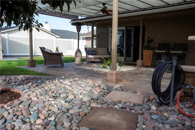 view of patio featuring fence and a ceiling fan