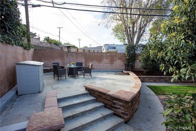 view of patio featuring outdoor dining area and a fenced backyard