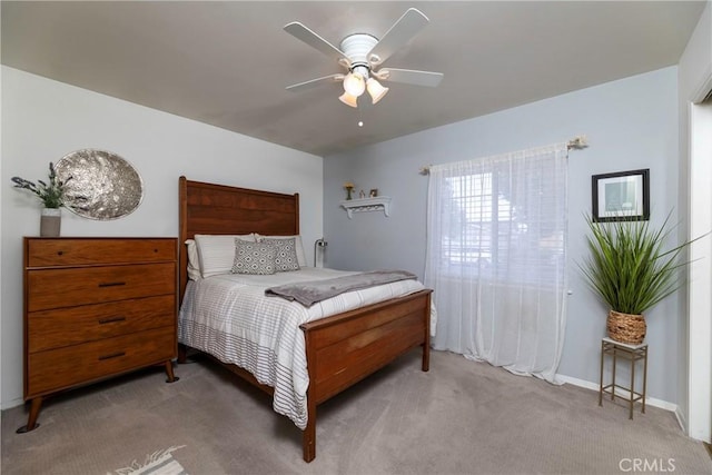 bedroom with baseboards, a ceiling fan, and light colored carpet