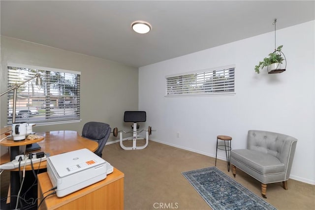 carpeted home office featuring baseboards