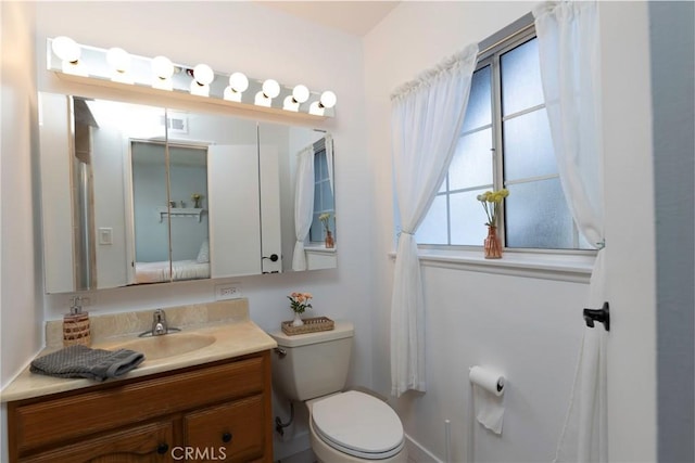 bathroom featuring toilet, visible vents, and vanity