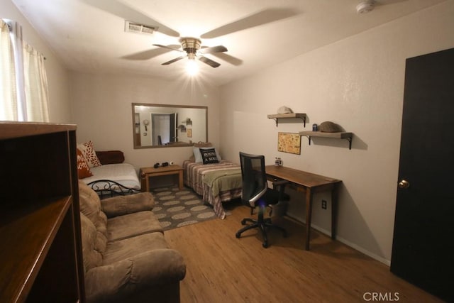 office area with lofted ceiling, visible vents, ceiling fan, and wood finished floors