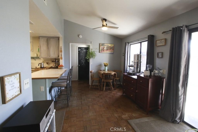 dining space with a ceiling fan and lofted ceiling