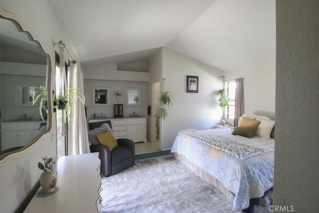 bedroom featuring vaulted ceiling and a sink