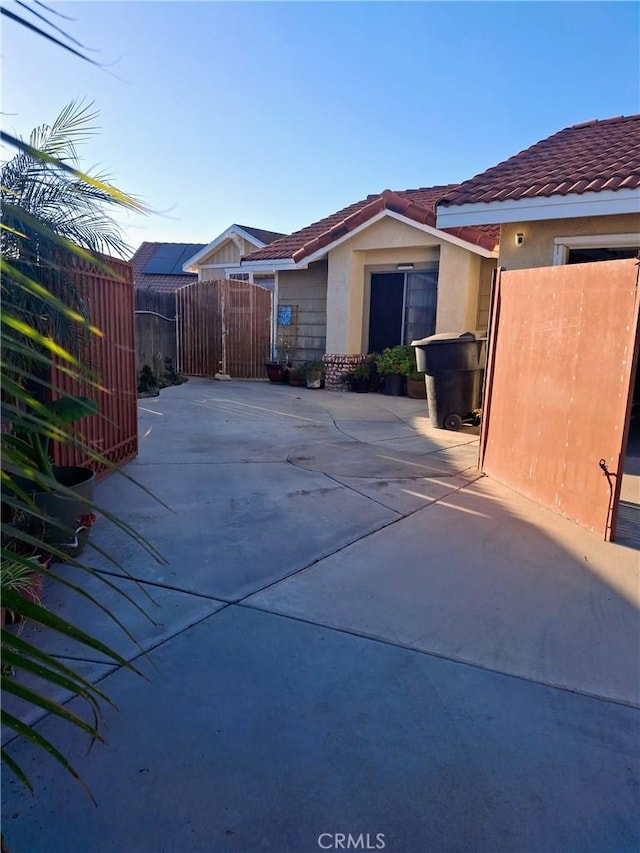 view of swimming pool with a patio and fence