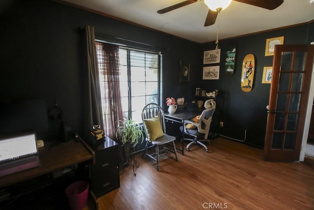 office area featuring ceiling fan, ornamental molding, and wood finished floors