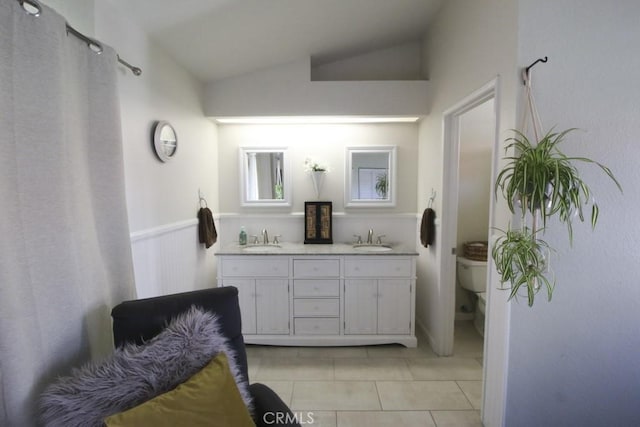 full bath featuring toilet, a sink, and lofted ceiling