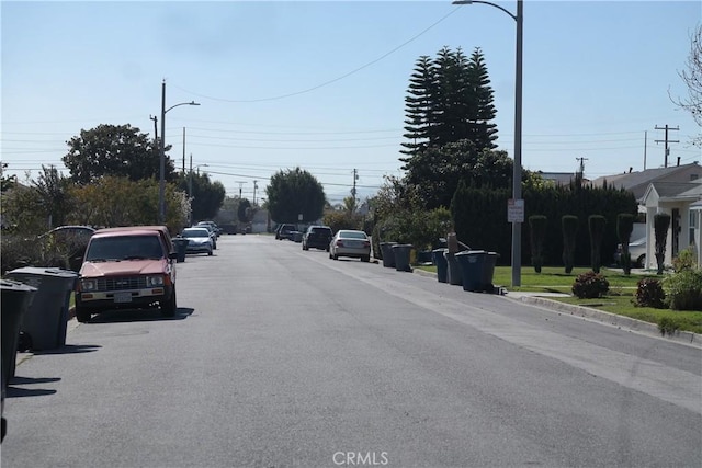 view of street with street lighting and curbs