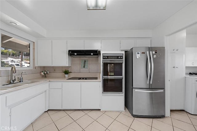 kitchen featuring white cabinets, under cabinet range hood, light countertops, black appliances, and a sink