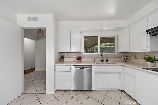 kitchen with light tile patterned flooring, a sink, white cabinets, light countertops, and stainless steel dishwasher