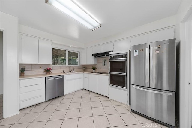 kitchen featuring a sink, white cabinets, light countertops, backsplash, and black appliances