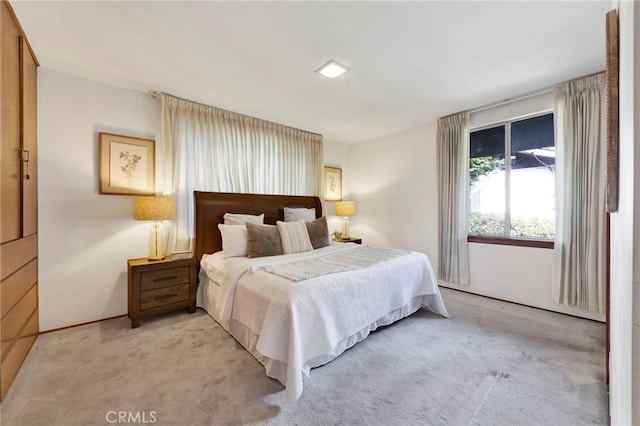 bedroom featuring light colored carpet