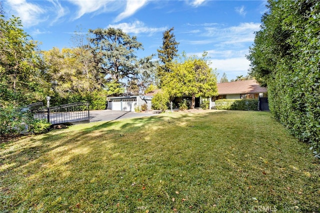 view of yard with a garage and fence