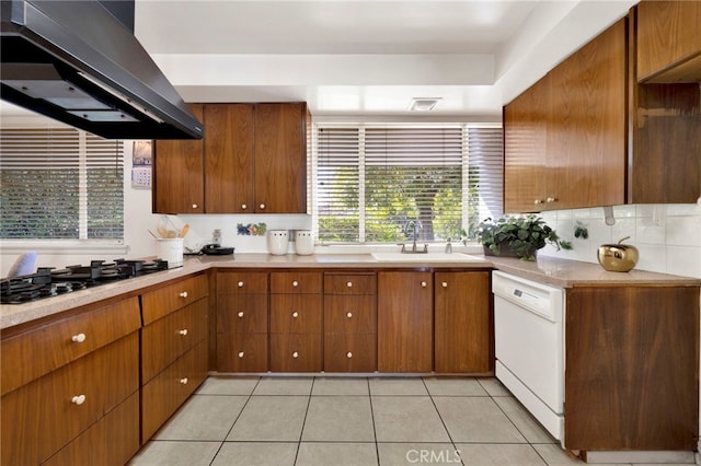 kitchen with white dishwasher, island exhaust hood, light countertops, and a sink