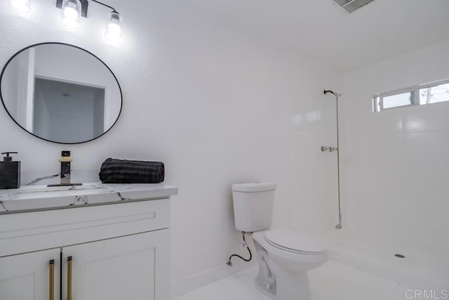 bathroom featuring toilet, visible vents, a shower, and vanity