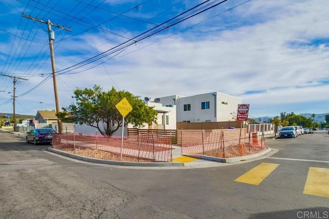 view of street featuring curbs, traffic signs, and sidewalks