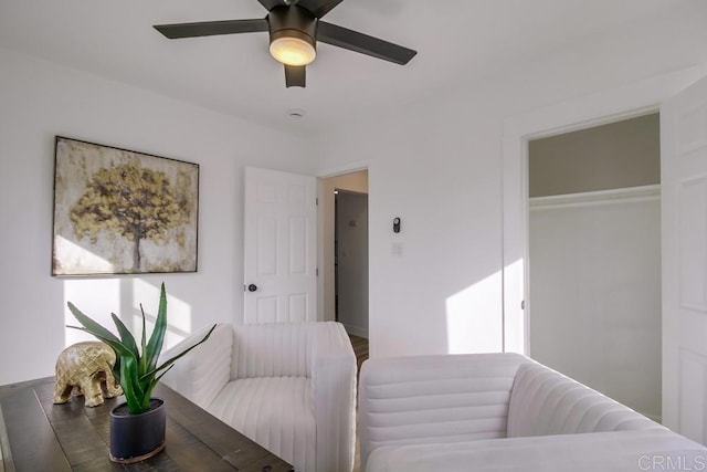 living area featuring a ceiling fan