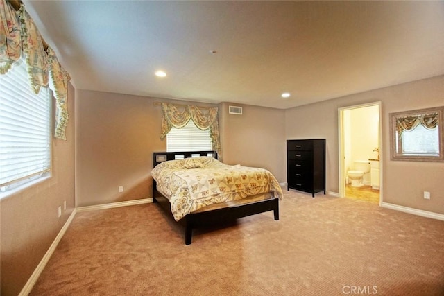 bedroom with recessed lighting, carpet floors, visible vents, baseboards, and ensuite bath