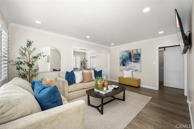 living area featuring ornamental molding, recessed lighting, dark wood-style flooring, and a barn door