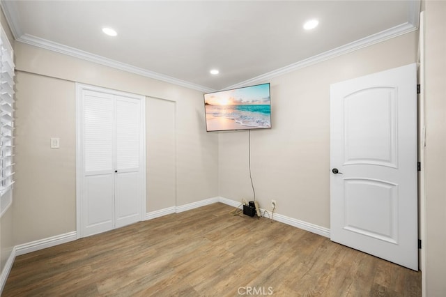 unfurnished bedroom featuring ornamental molding, recessed lighting, and wood finished floors