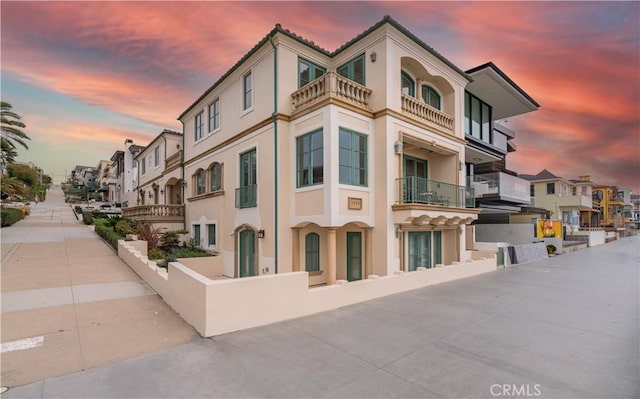 property at dusk featuring a residential view