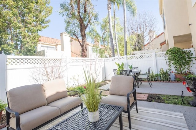 view of patio with outdoor dining area and a fenced backyard