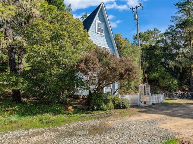 view of side of property featuring fence