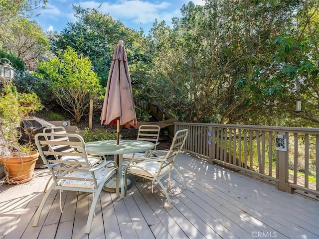 wooden terrace featuring outdoor dining space