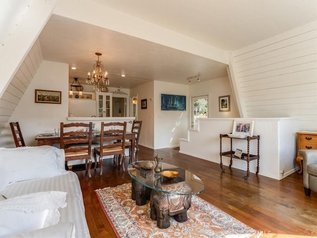 living room featuring a chandelier and dark wood finished floors