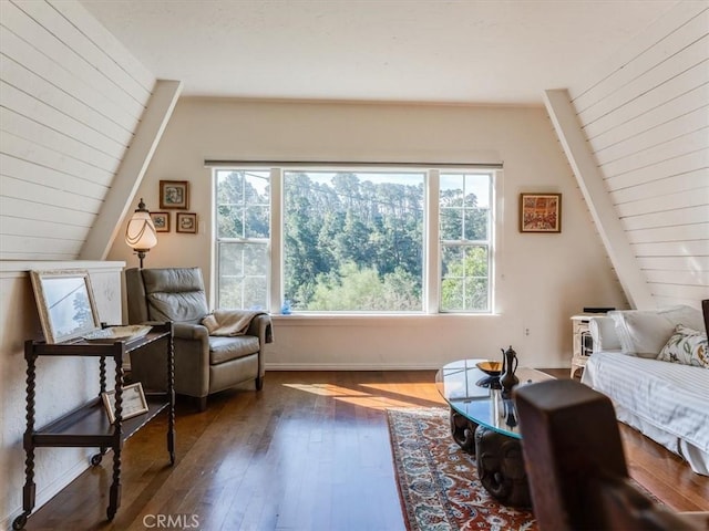 sitting room featuring lofted ceiling and dark wood-style flooring