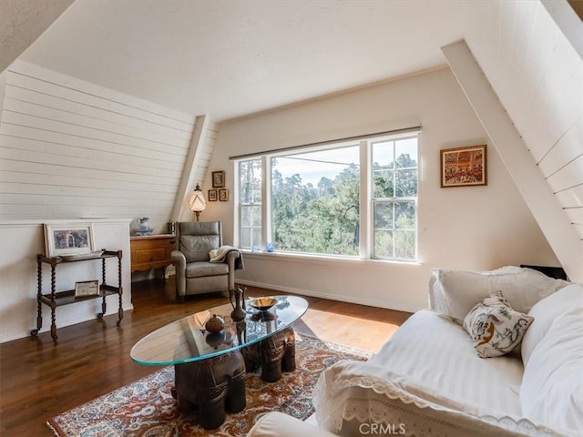 sitting room featuring baseboards, vaulted ceiling, and dark wood-style flooring