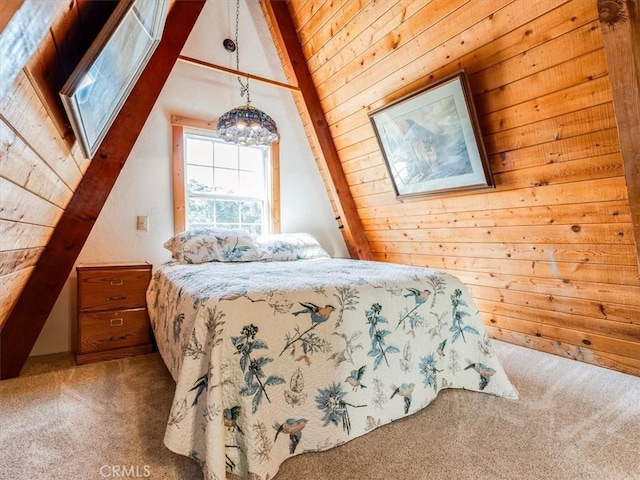 carpeted bedroom featuring vaulted ceiling with skylight and wooden walls