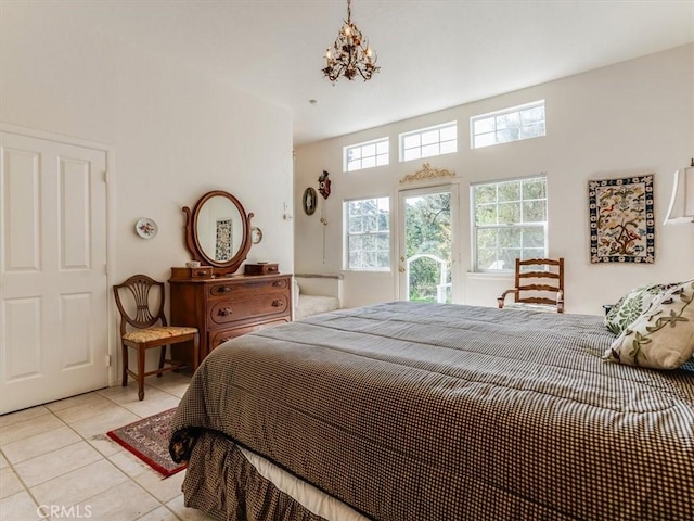 bedroom featuring light tile patterned flooring and an inviting chandelier