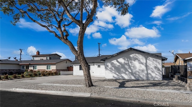 view of front of property with driveway and fence