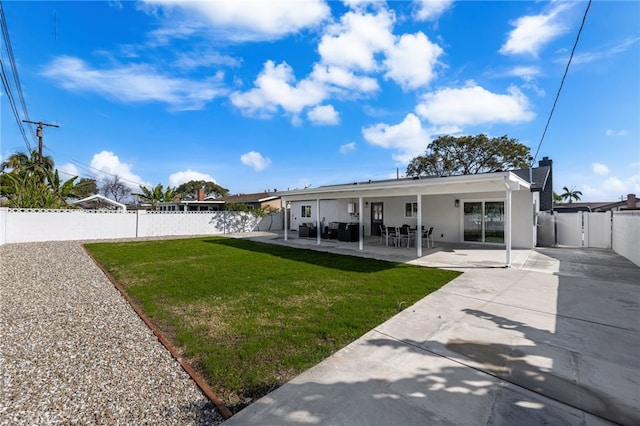 rear view of property with fence private yard, a patio area, and a lawn