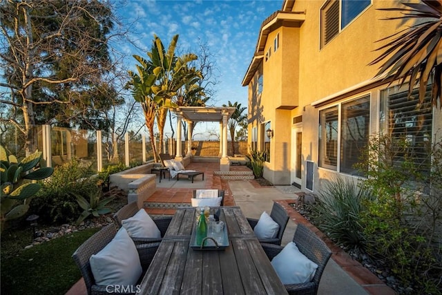 view of patio with a fenced backyard, an outdoor hangout area, a pergola, and outdoor dining space