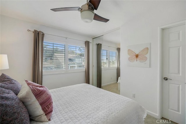 bedroom with a ceiling fan and baseboards