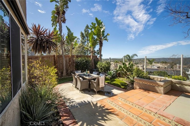 view of patio with outdoor dining space and a fenced backyard