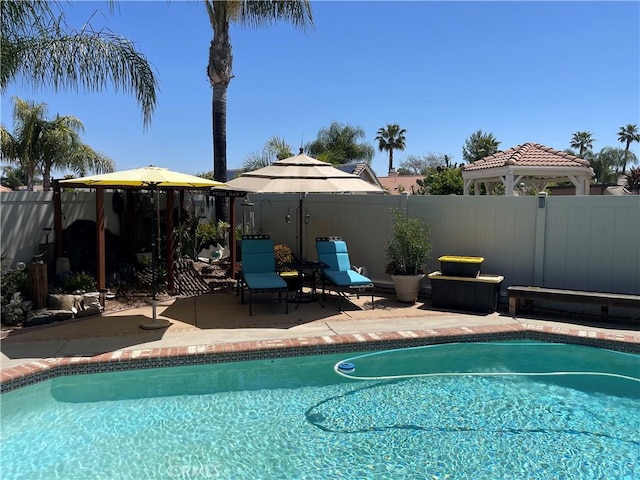 view of pool with a fenced in pool, a patio area, fence, and a gazebo