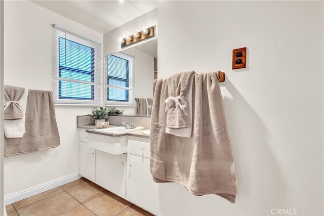 bathroom featuring vanity, baseboards, and tile patterned floors