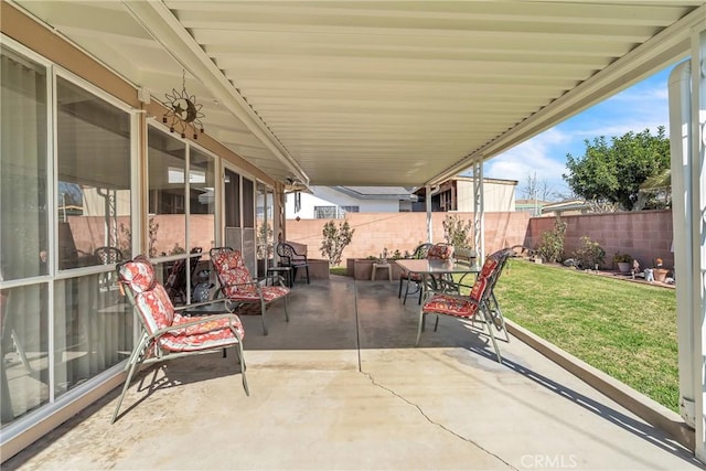 view of patio with outdoor dining area and a fenced backyard