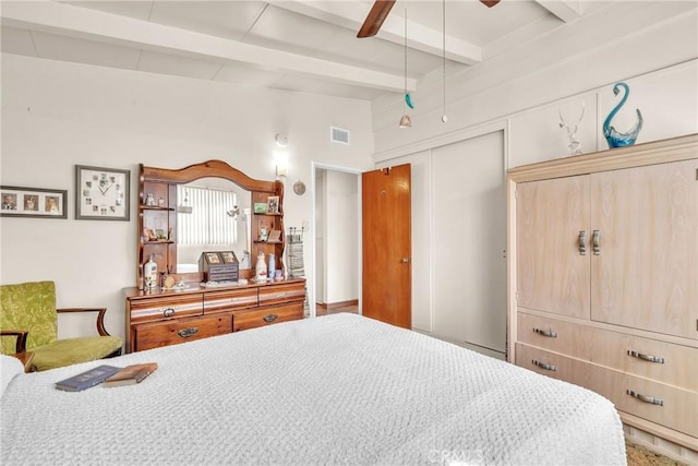 bedroom featuring vaulted ceiling with beams, a closet, visible vents, and a ceiling fan