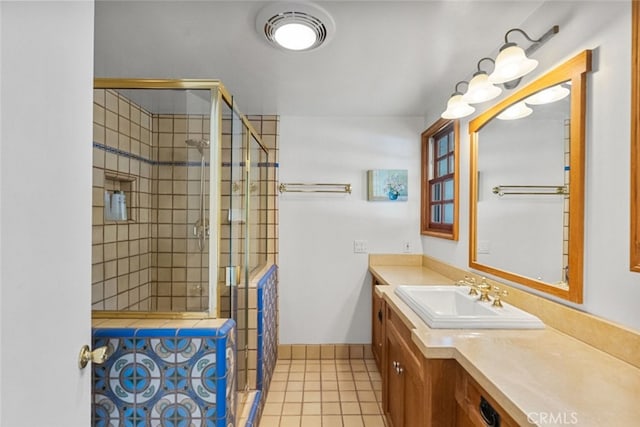 bathroom featuring baseboards, a shower stall, vanity, and tile patterned floors